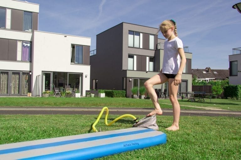Girl pumping up the blue AirBeam with a Foot pump