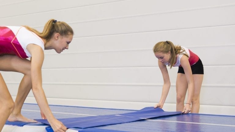 2 gymnasts placing a Trackconnect between 2 AirTracks