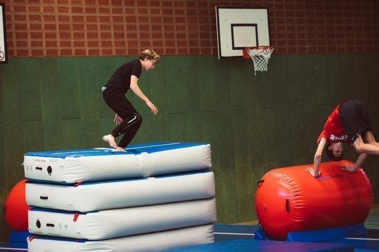 Boy sjumping of an AirBox (an inflatable vaulting table)