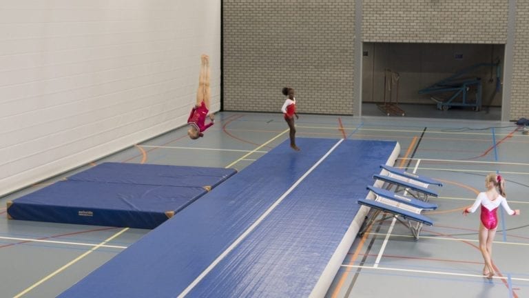 gymnasts tumbling on blue airtrack p3