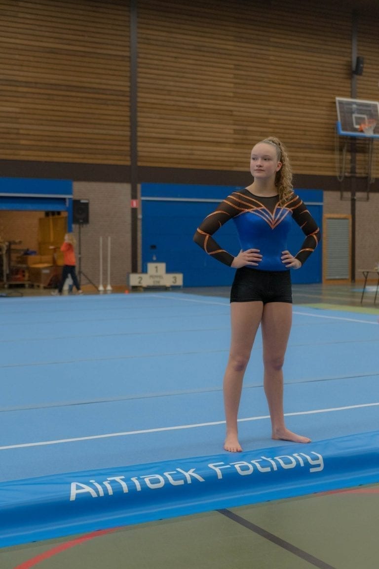 Gymnast standing on AirTrack Competition Floor
