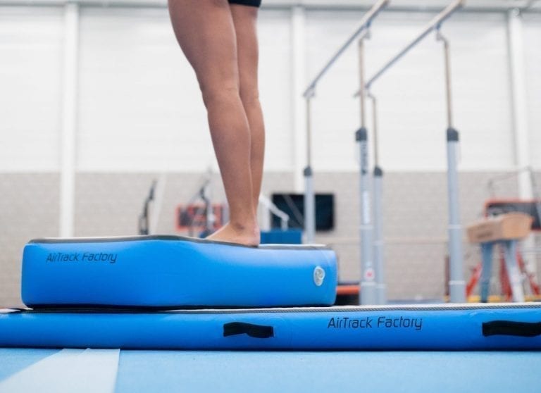 Gymnast standing on blue AirBlock