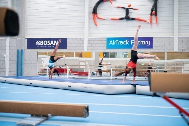 2 gymnasts tumbling on airtrack